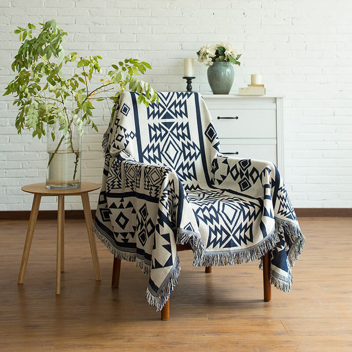Cozy knitted throw blanket in a bohemian style with decorative tassels.
