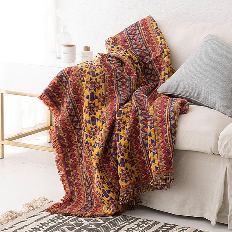 Warm & cozy bohemian knitted throw blanket featuring elegant tassels.