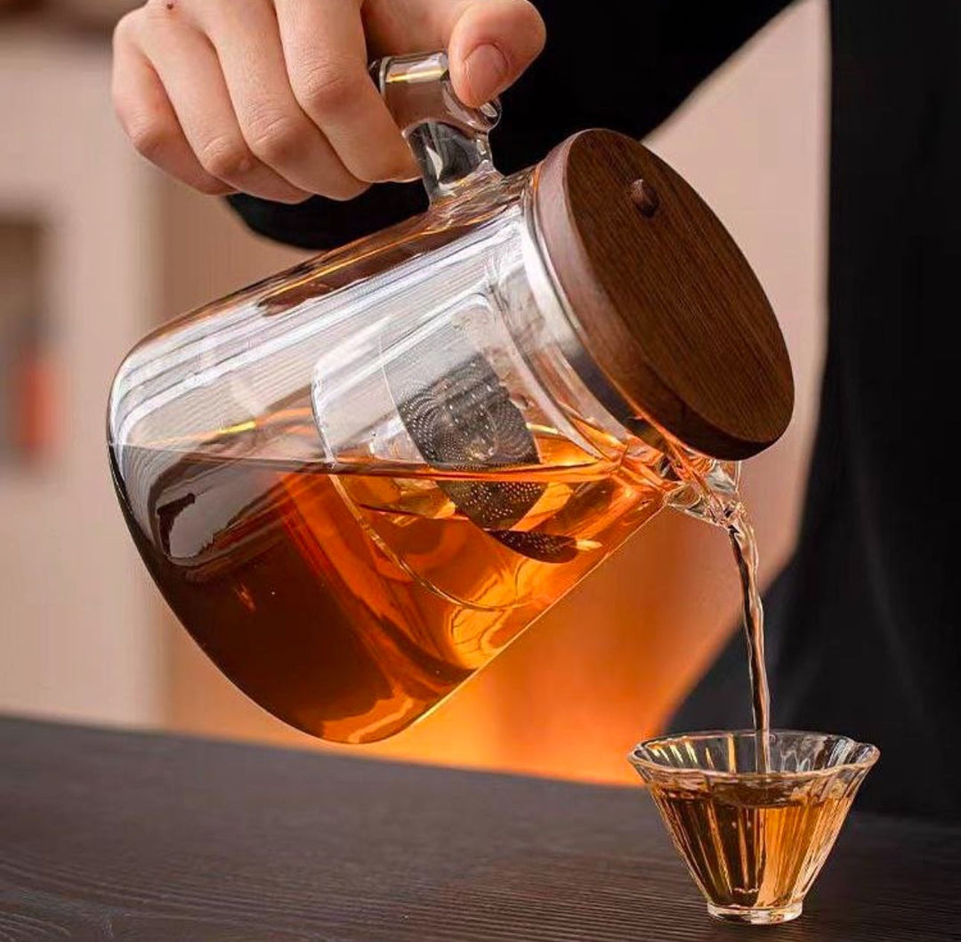 Elegant stovetop teapot made of durable borosilicate glass, featuring a fine mesh tea infuser.