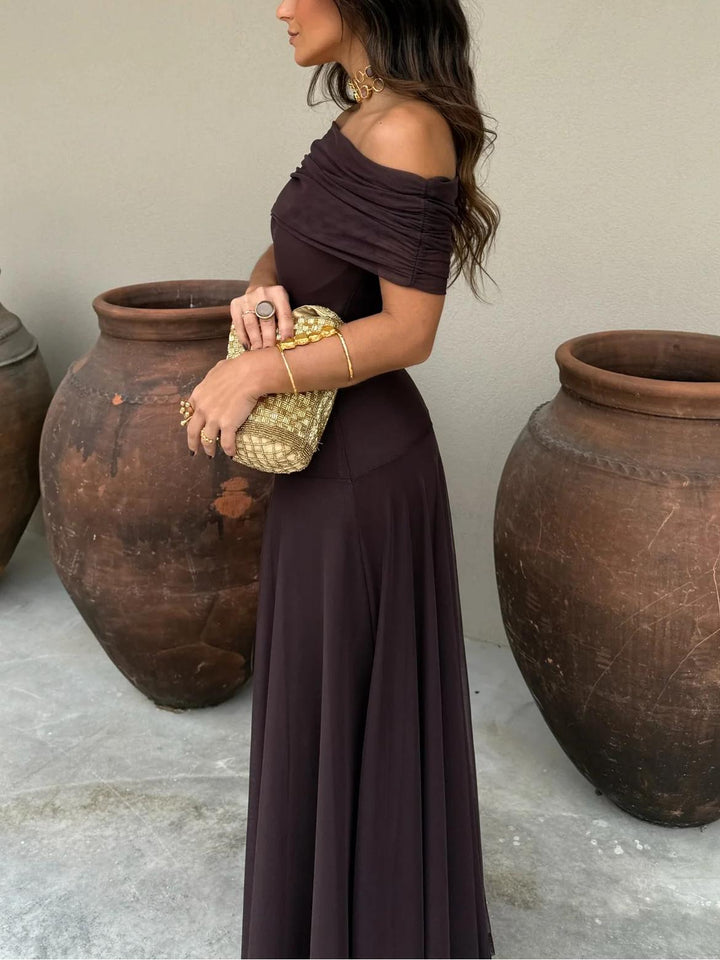 Comfortable brown off-shoulder maxi wedding guest dress with elegant mesh overlay. Flowy and stylish for formal parties.