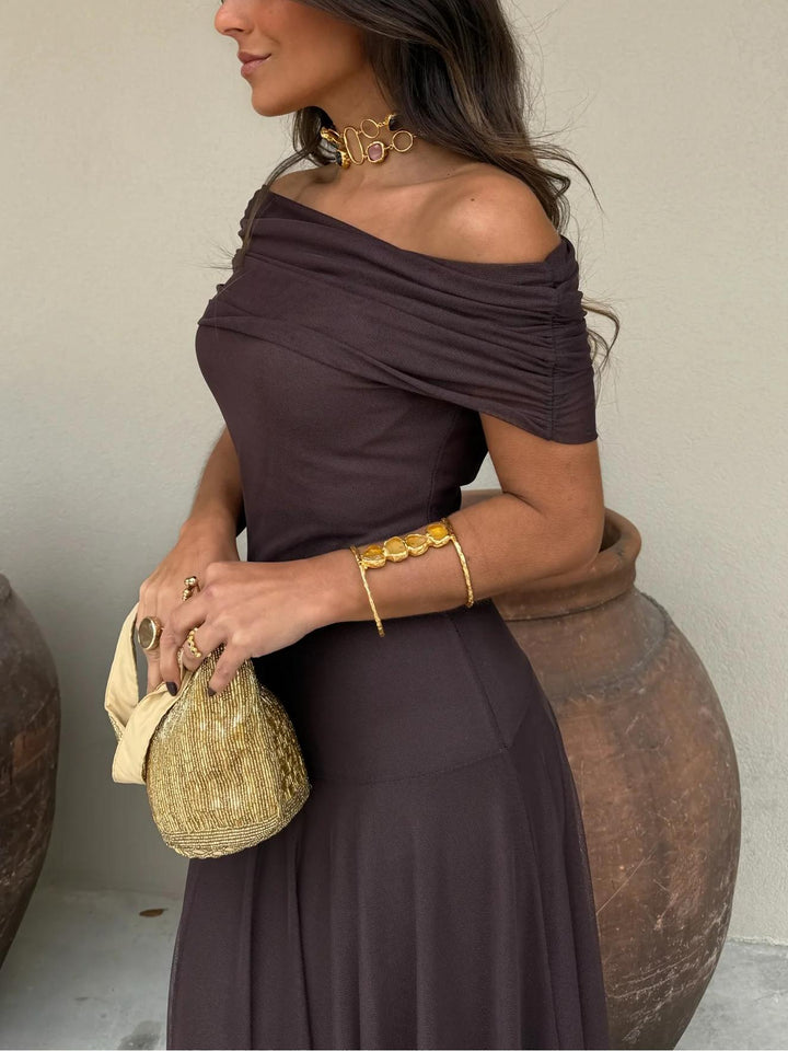 Brown flowy maxi dress for women, elegant off-shoulder design with a delicate mesh overlay. Perfect wedding guest attire.