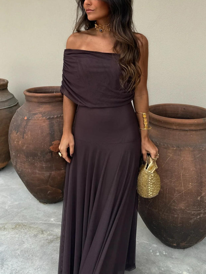 Chic brown off-shoulder maxi dress, women's formal wedding guest attire. Features an elegant, ethereal mesh overlay.