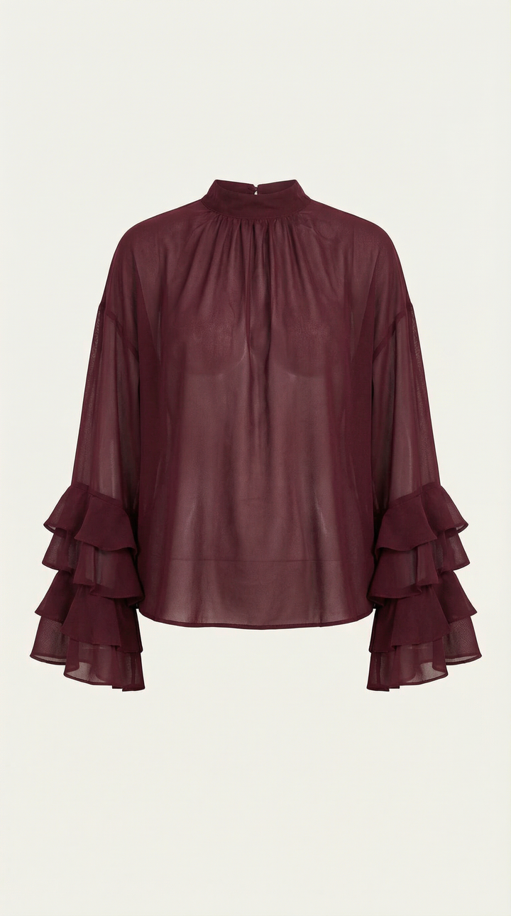 Stylish burgundy sheer top featuring a high mock neck and voluminous tiered ruffle sleeves.