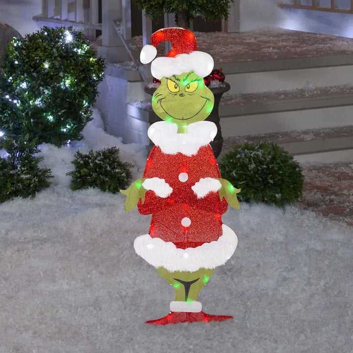 Cheerful Grinch outdoor Christmas display. Green character yard light for festive holiday garden decor.