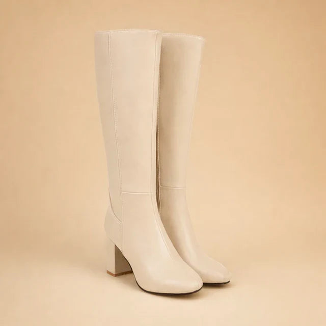 Stylish beige over-the-knee high heel boots for women. Comfortable & chic winter footwear, perfect for elegant outfits.
