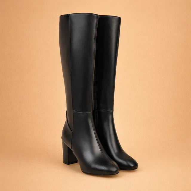 Elegant brown women's over-the-knee high heel boots. Chic winter fashion, perfect stylish footwear for dress boots.