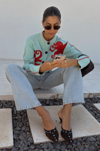 Coastal inspired blue cardigan showcasing a unique octopus embroidery, perfect for sea lovers.