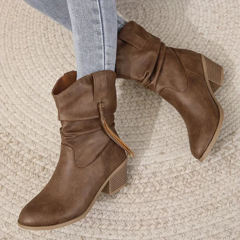 Fashionable brown women's western ankle boots with tassels, providing chic and comfortable fall footwear.