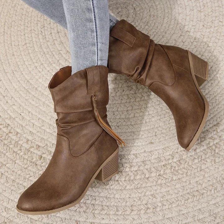 Fashionable brown women's western ankle boots with tassels, providing chic and comfortable fall footwear.