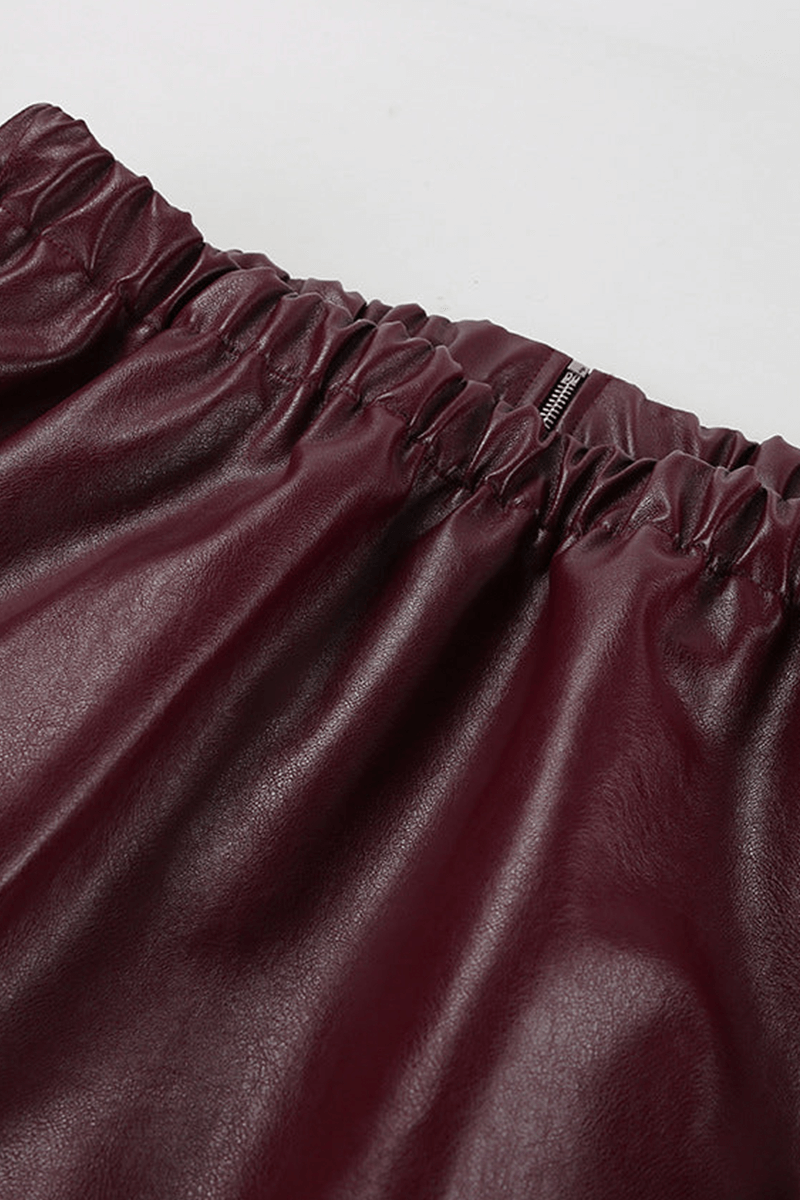 Collar detail of a women's chic burgundy cropped jacket, highlighting its modern style.