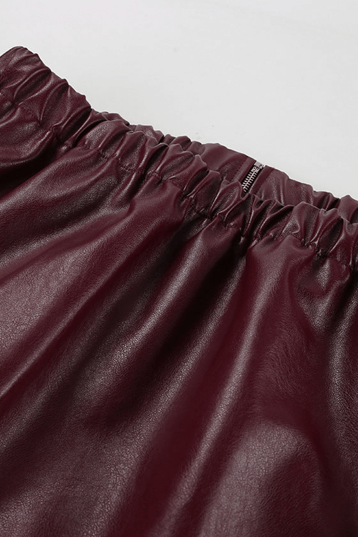 Collar detail of a women's chic burgundy cropped jacket, highlighting its modern style.