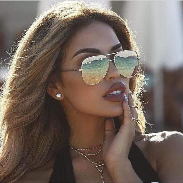 Timeless style women's aviator sunglasses, gold frame fashion accessory.