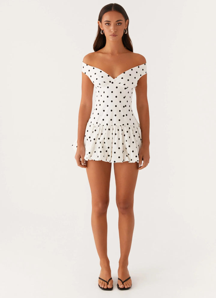Women's fashion: adorable polka dot peplum mini dress, ideal for casual or party wear.