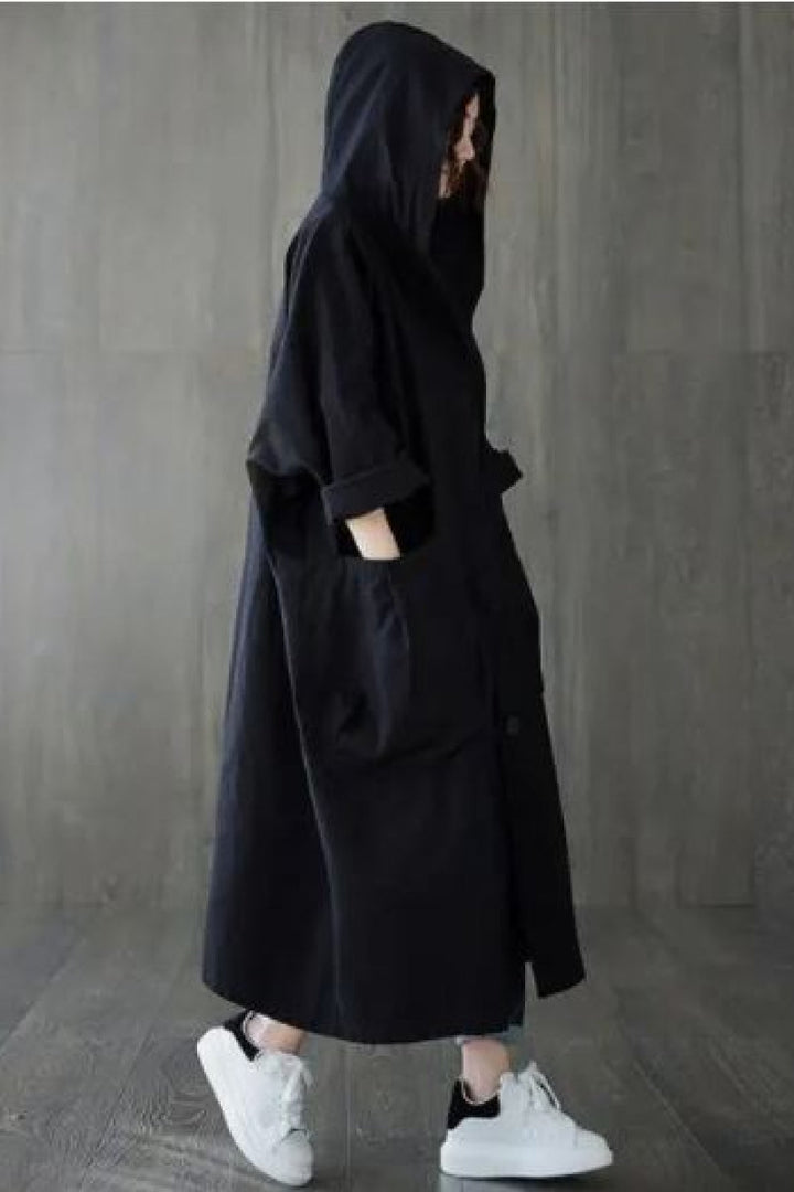 Detail of women's waterproof windbreaker hood, featuring chic oversized design & lightweight fabric.