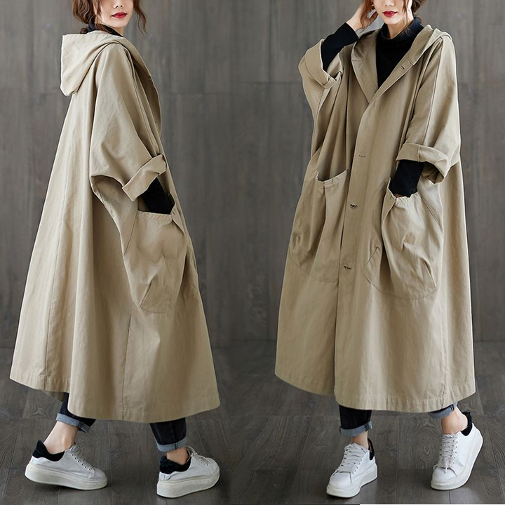Woman wearing lightweight oversized windbreaker, stylish outerwear for sunny fall days.