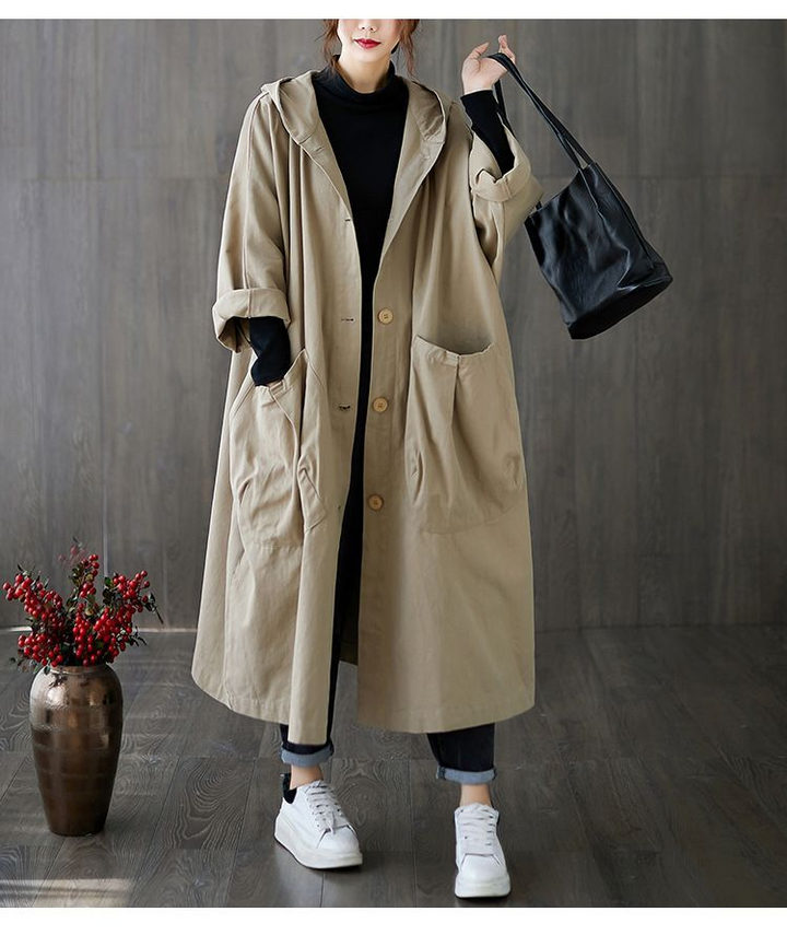 Smooth fabric of women's waterproof windbreaker, oversized for comfort, chic for style & rain.