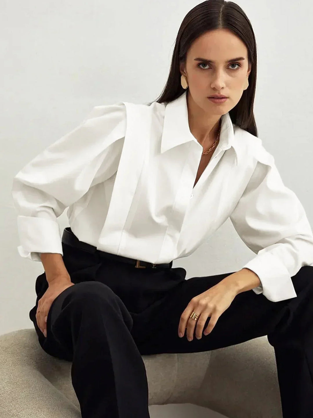 Women's chic white boxy button-down shirt styled with modern elegance for versatile everyday outfits.