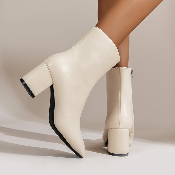 Chic women's ankle boots with stable block heel, perfect for fall and winter fashion. Versatile and elegant footwear.