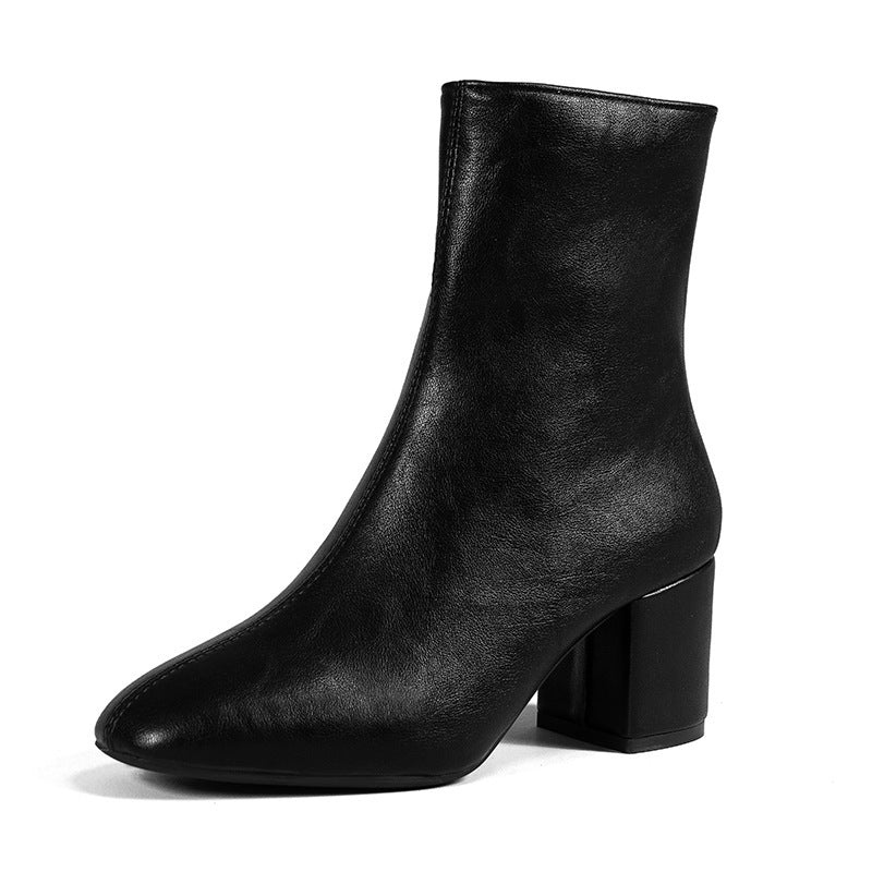 Close-up of chic women's ankle boots with a stable block heel, highlighting elegant design and quality.