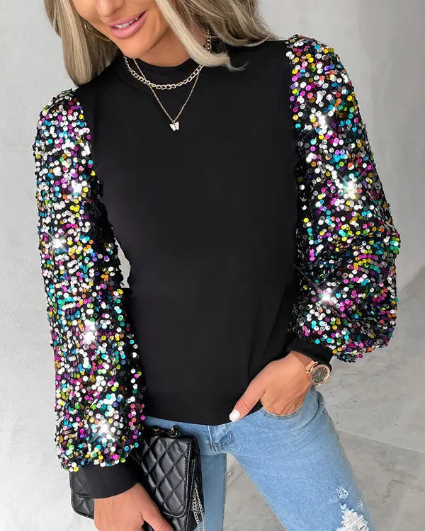Fashionable long-sleeve blouse featuring dramatic balloon sleeves and sparkling sequin embellishments for a statement look.