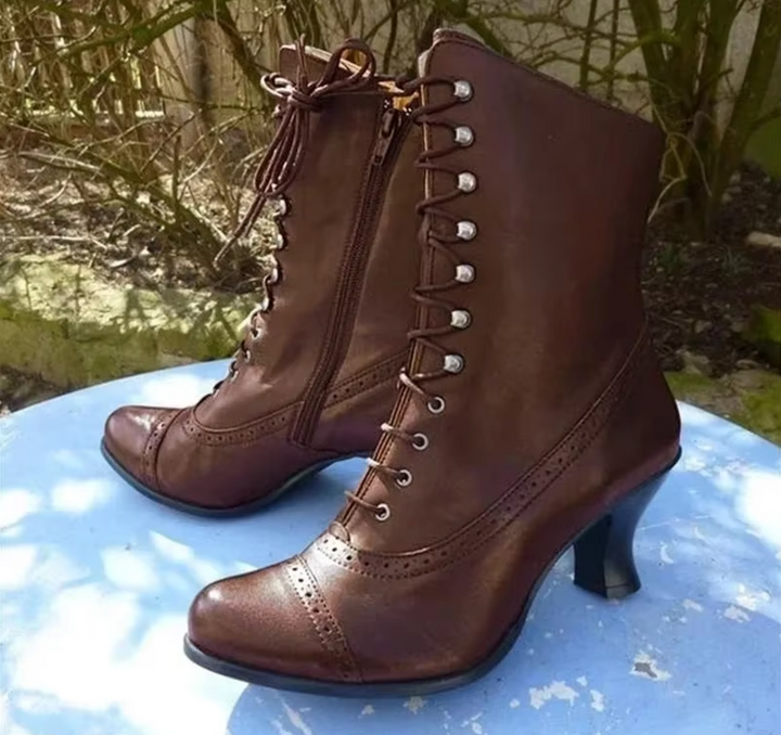 Chic women's black lace-up platform boots with pointed toe, trendy ankle-height fashion footwear for stylish comfort.
