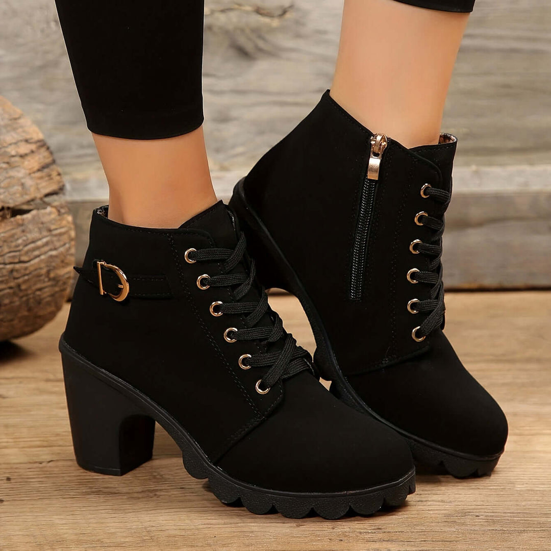 Women's block heel ankle boots showcasing prominent buckle detail. Modern and chic fashion footwear.