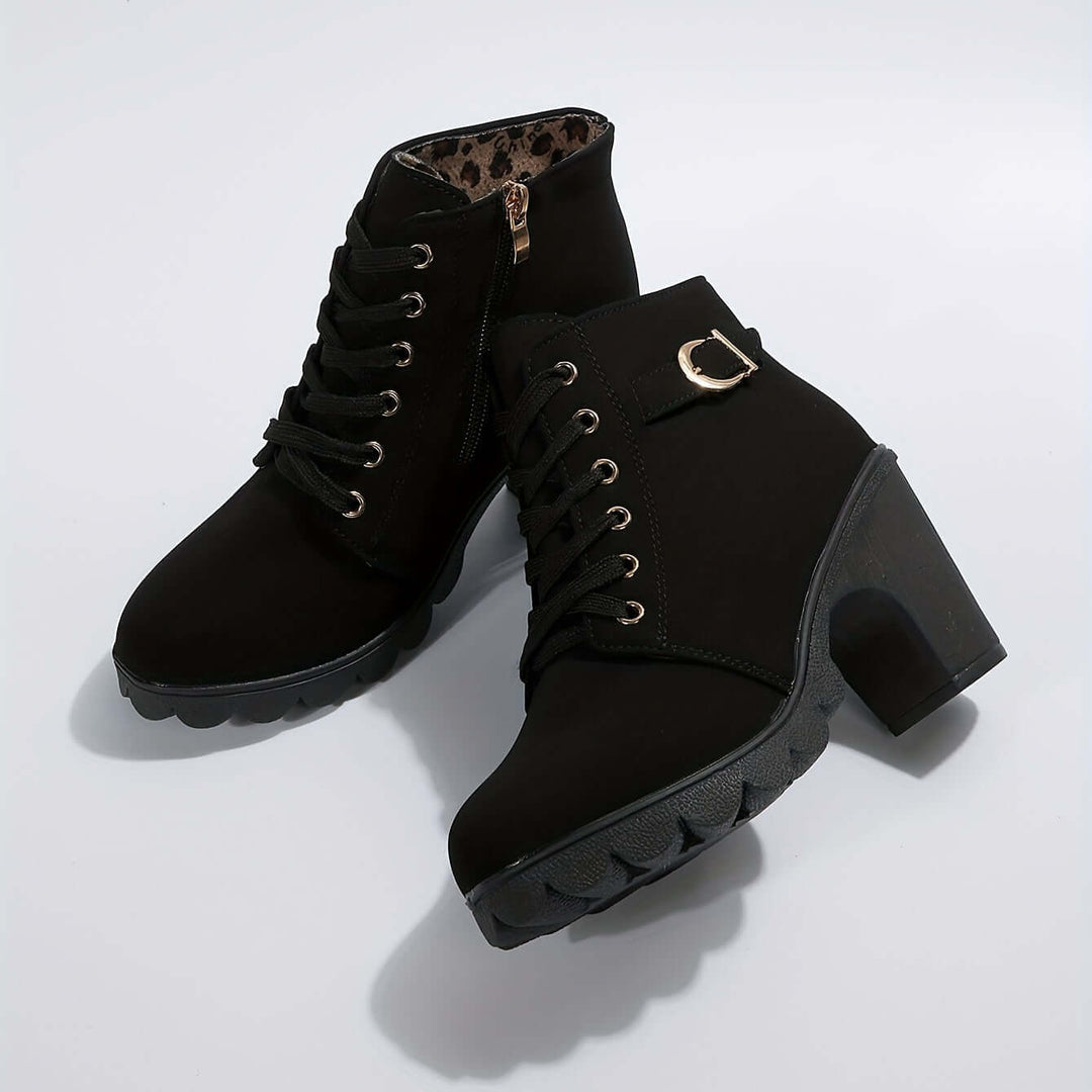 Women's stylish block heel ankle boots. Features chic buckle detail for comfortable and fashionable wear.