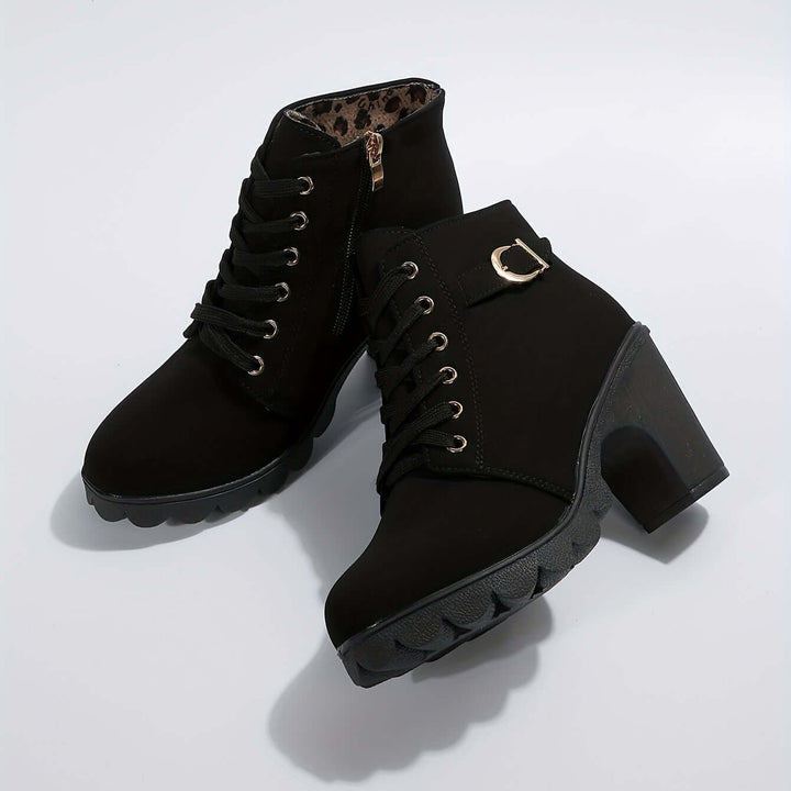 Women's stylish block heel ankle boots. Features chic buckle detail for comfortable and fashionable wear.