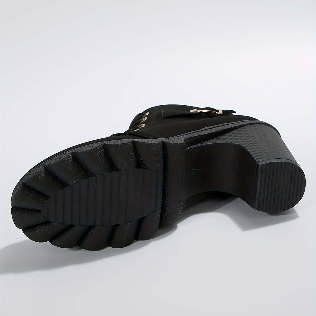 Modern women's block heel ankle boots with sophisticated buckle accents. Essential stylish fall footwear.