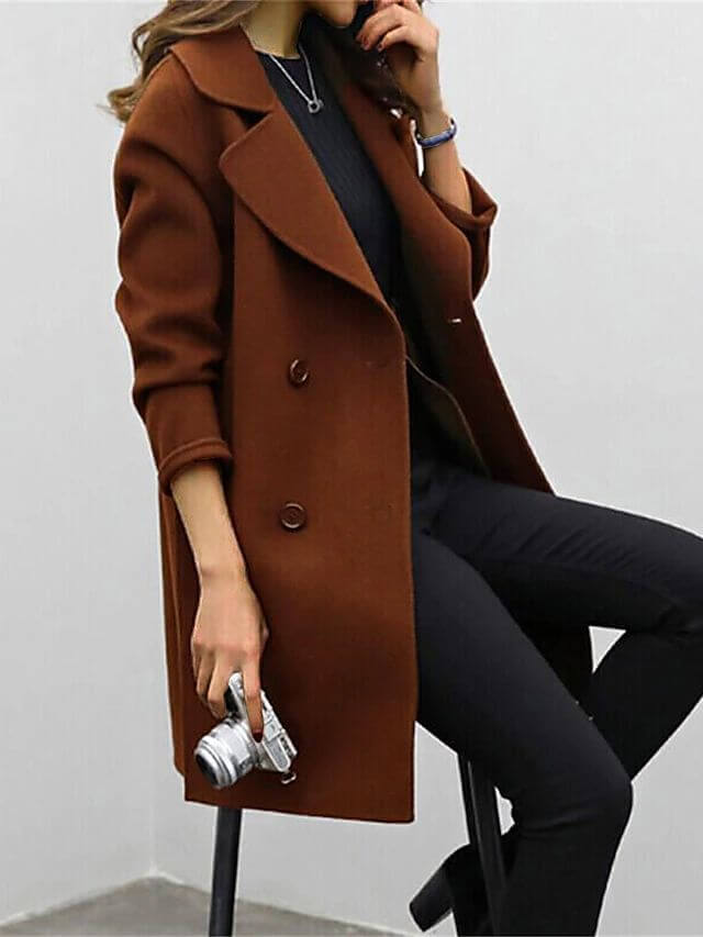 Warm women's long double-breasted winter coat. Elegant and classic outerwear jacket for sophisticated cold-weather fashion.