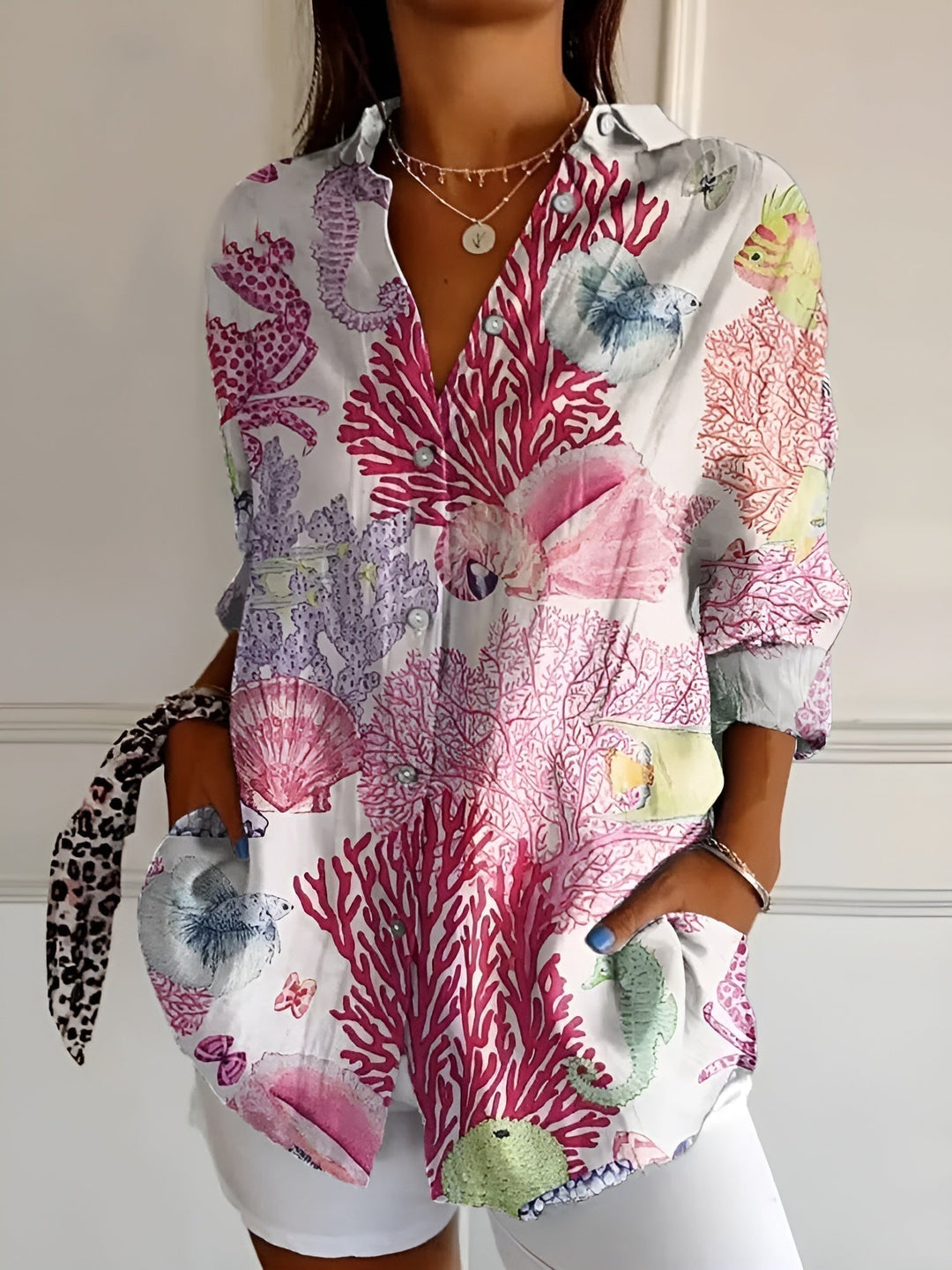 Stylish women's summer blouse, loose-fit floral print with functional button front, great for warm weather.
