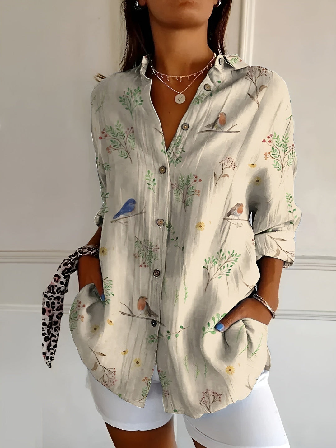 Women's comfortable button-front blouse featuring a beautiful floral print, a versatile top for summer wear.