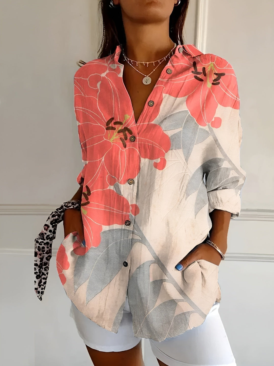 Casual women's blouse with a vibrant floral print and button front, a comfortable and chic summer fashion essential.