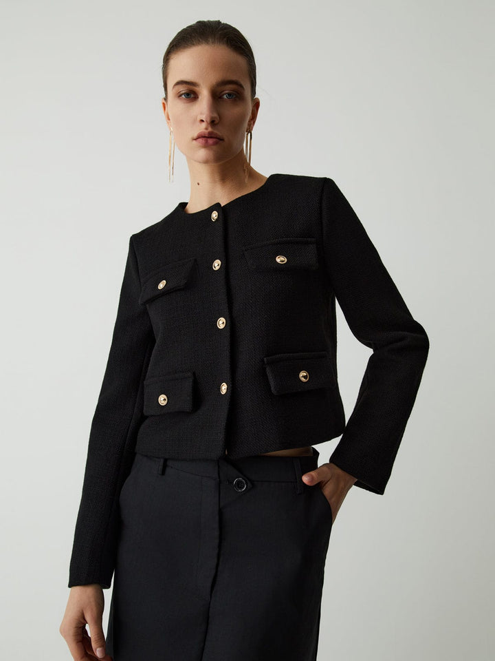 Elegant women's cropped jacket featuring chic gold buttons. Smart casual outerwear for a polished look.
