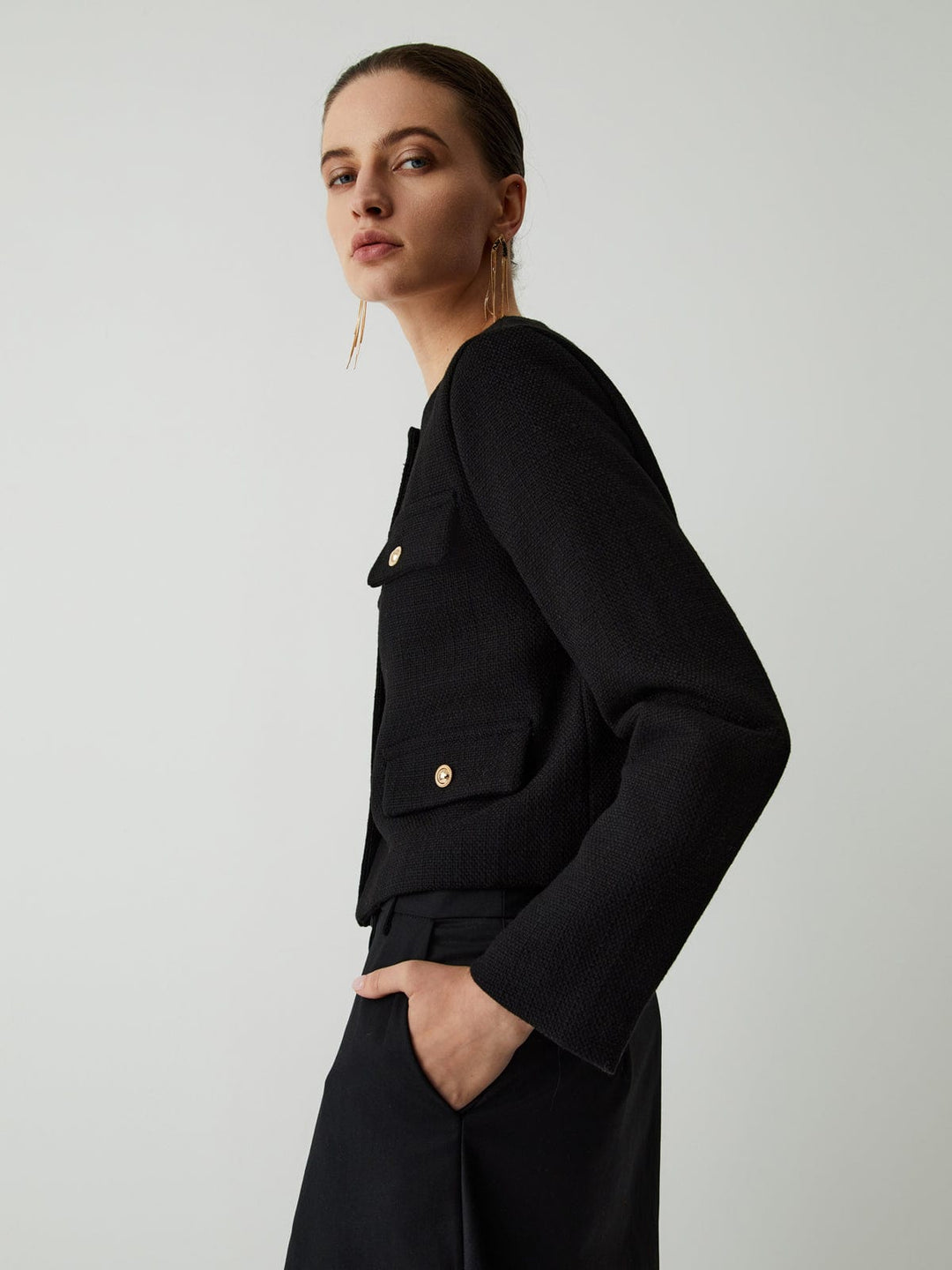 Tailored women's gold-button cropped blazer. Stylish and versatile long sleeve jacket for work or events.
