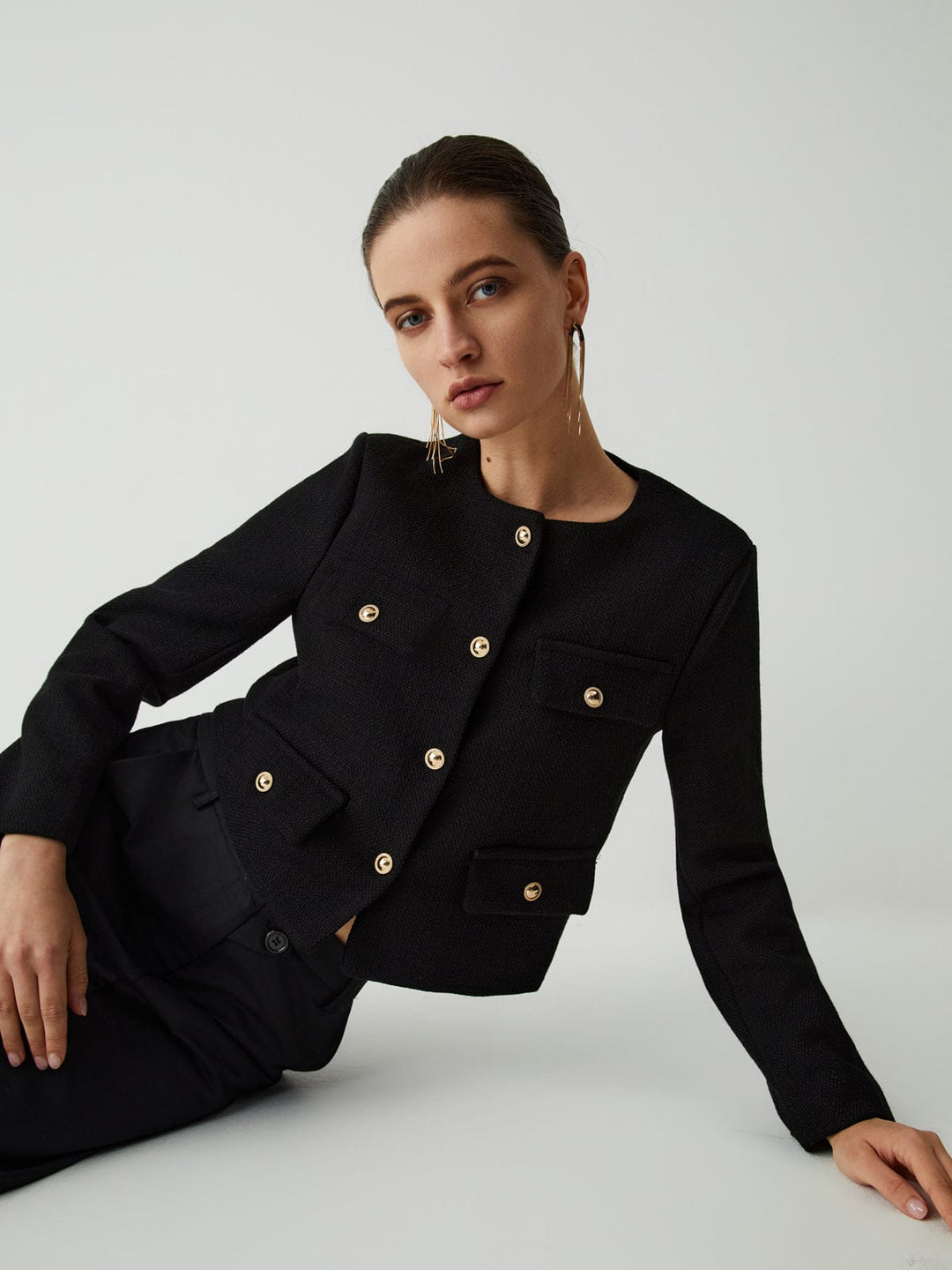 Sophisticated women's gold-button cropped blazer. Modern tailored jacket, perfect for workwear fashion.