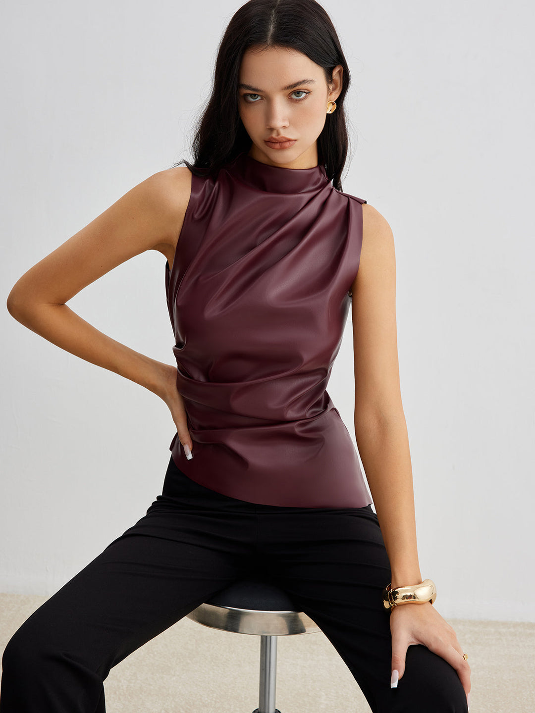 Chic women's high neck drape top. Elegant sleeveless design for modern office or evening wear.
