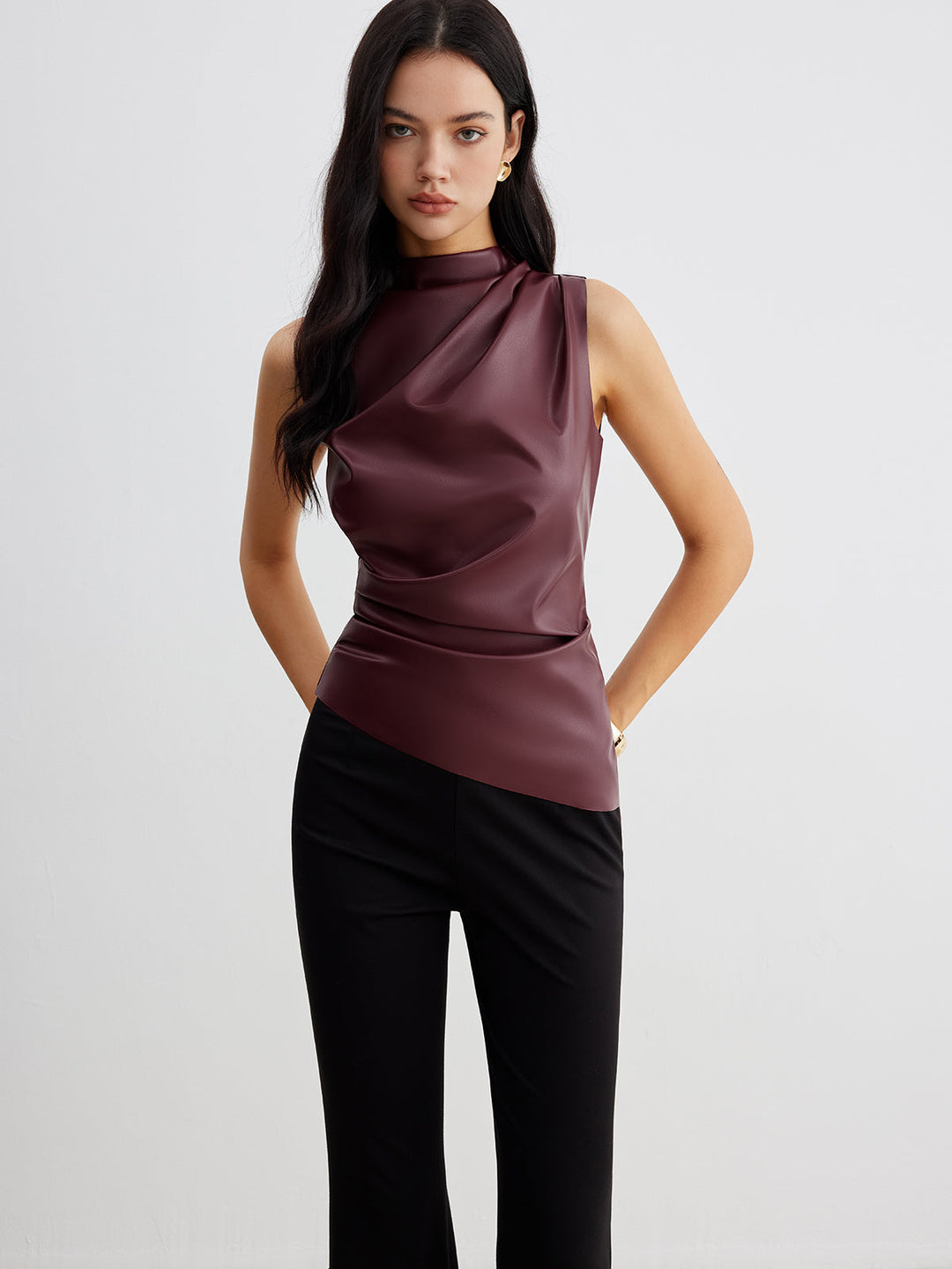 Sleeveless high neck women's top with elegant drape. Versatile for formal or casual chic outfits.