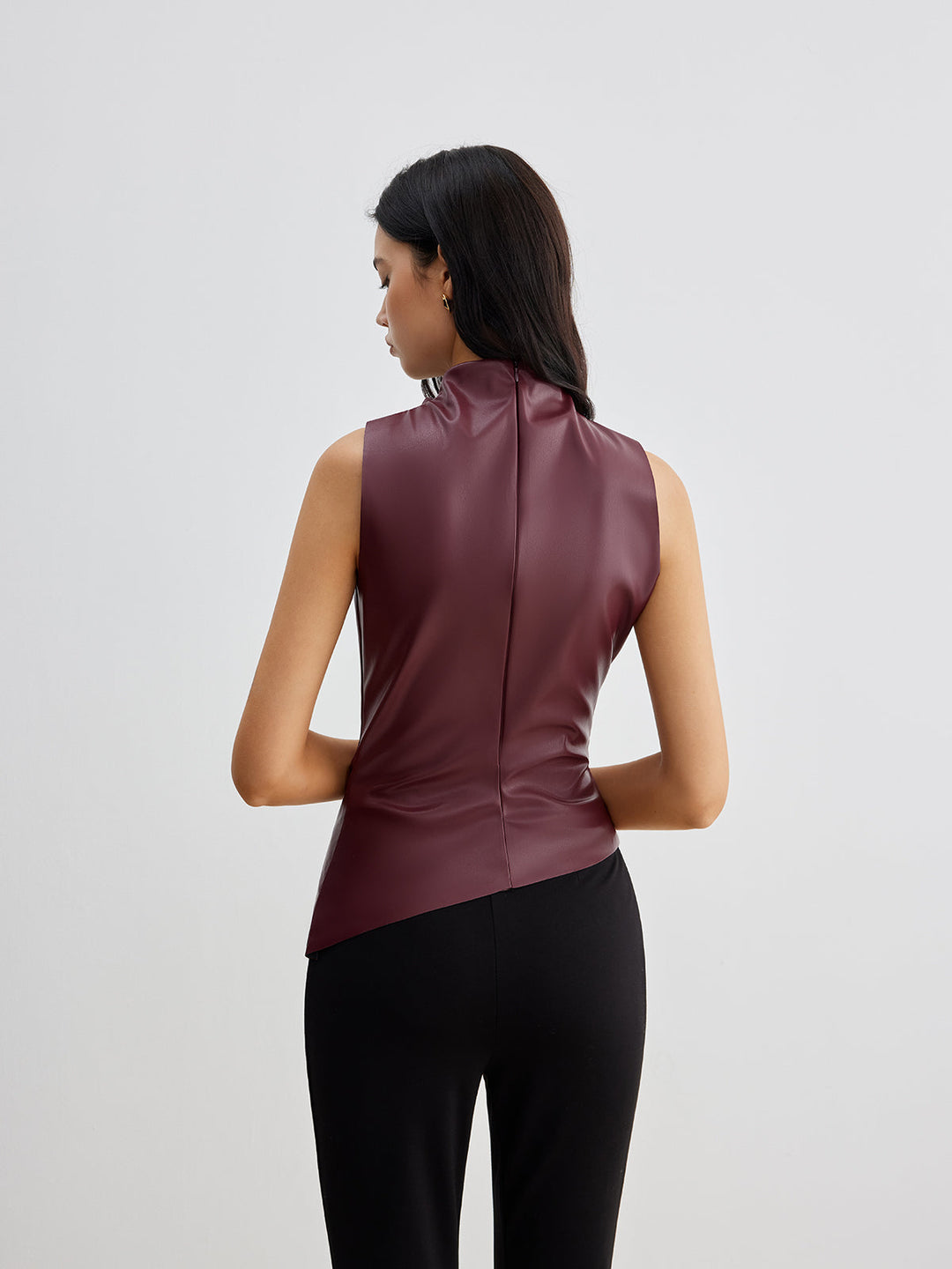 Elegant women's sleeveless top with a high neck and flattering draped silhouette. Great for evening wear.