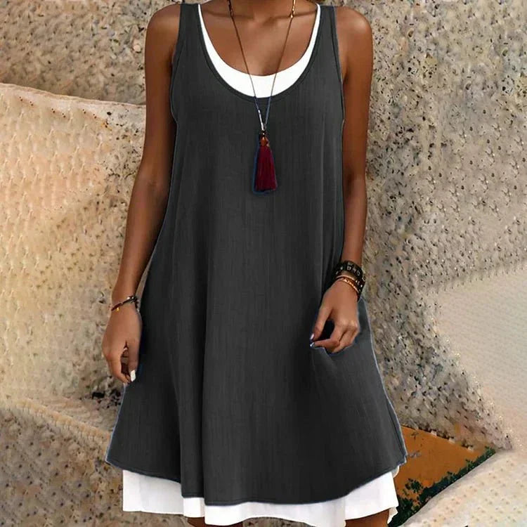 Chic women's layered mini dress with a scoop neck and sleeveless design, perfect for summer casual wear.