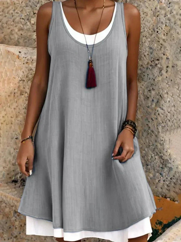 Elegant women's sleeveless scoop neck mini dress, a swing style layered design ideal for casual summer outings.