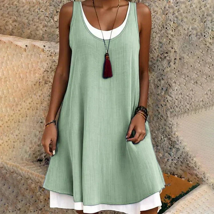 Fashionable women's chic layered mini dress, sleeveless with a scoop neck, offering comfort & style for summer.