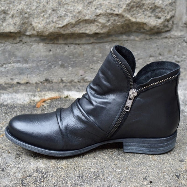 Chic women's leather ankle boots with side-zip closure & ruched detail. Stylish low heel for versatile everyday wear.