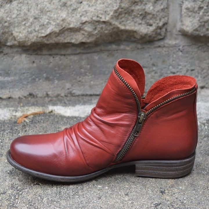 Stylish women's leather ankle boots with sleek side-zip & trendy ruched detailing. Effortless chic low heel footwear.