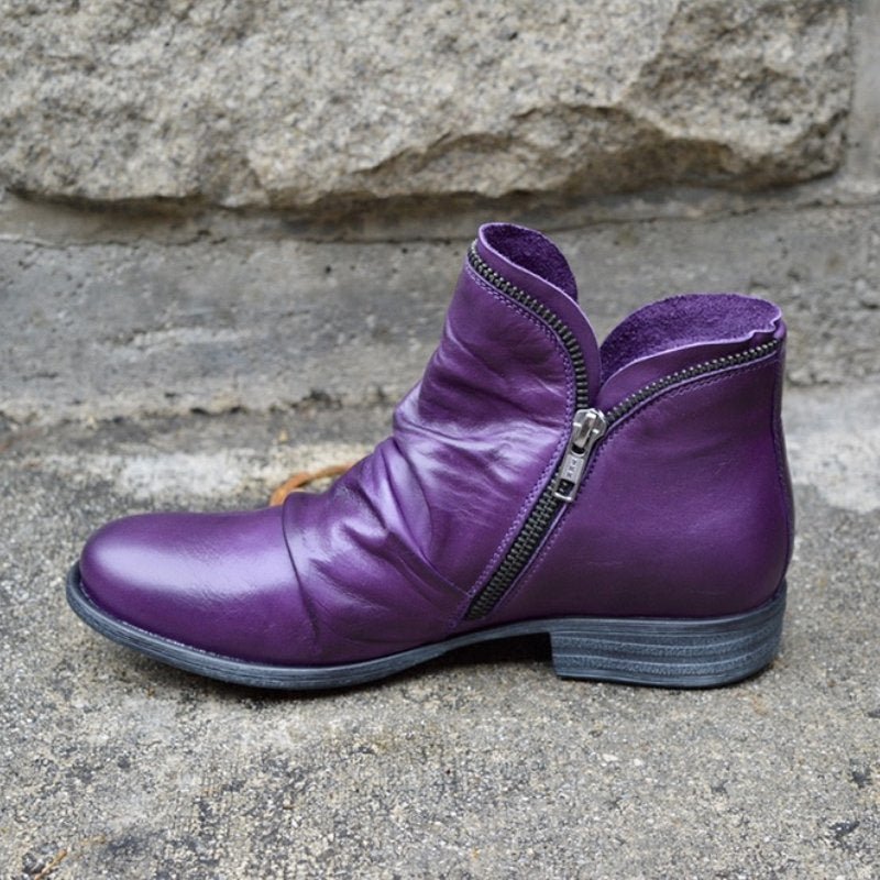 Versatile women's chic leather ankle boots. Features a convenient side-zip, ruched accents & comfortable low heel.