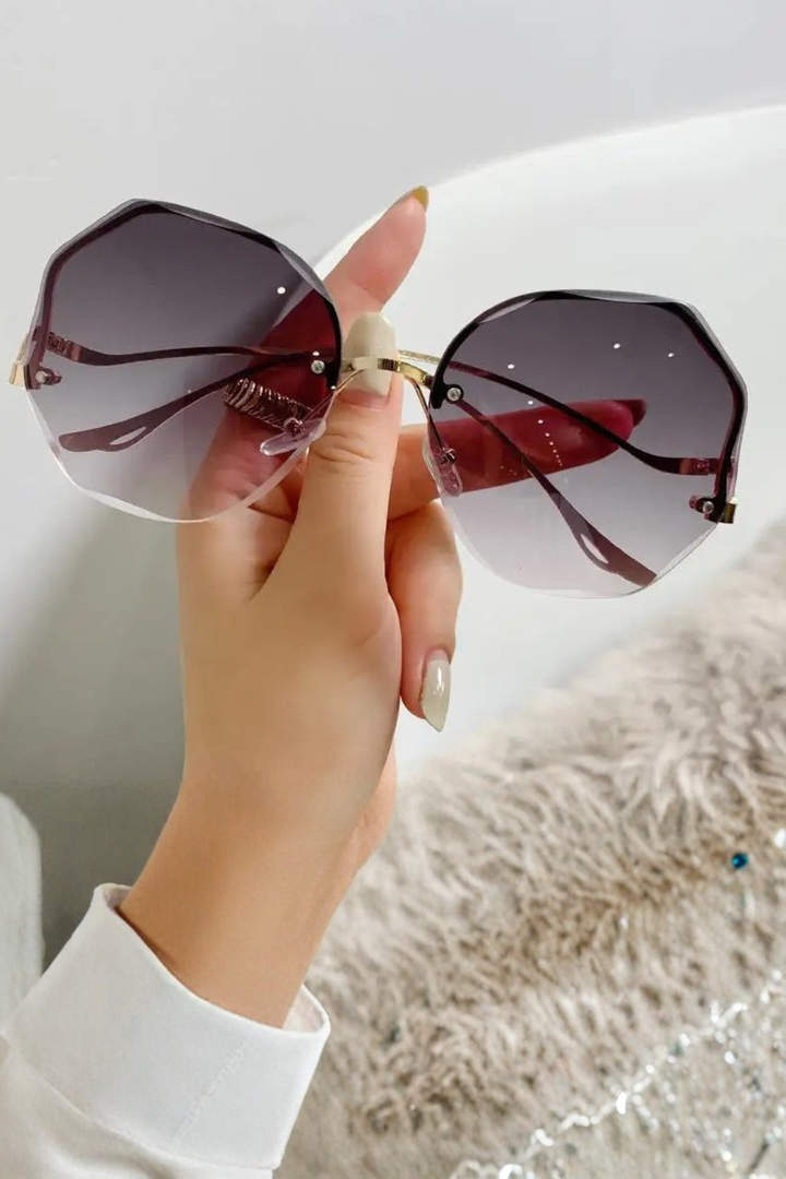 Geometric oversized rimless women's sunglasses with gradient lenses, a modern eyewear statement.