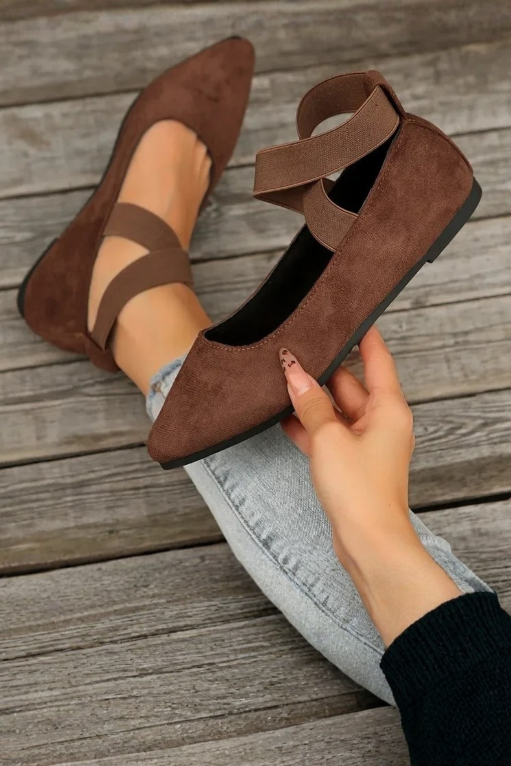 Modern women's pointed toe flats featuring a stylish ankle strap, perfect for versatile fashion looks.