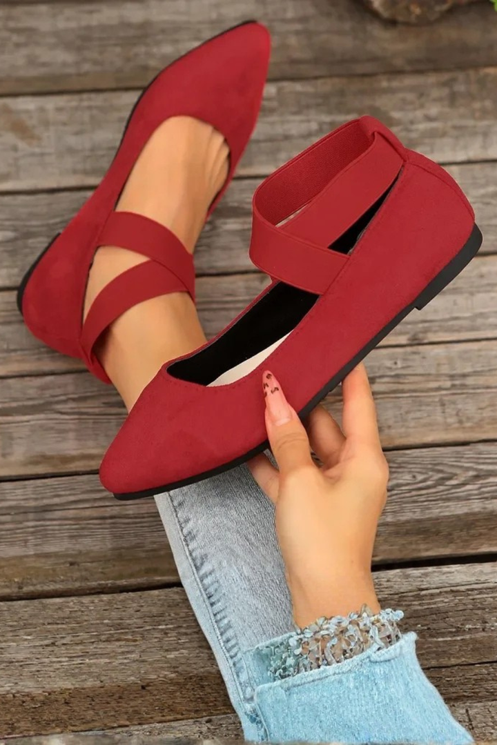 Close-up of women's pointed toe ballet flat, highlighting the elegant ankle strap and sleek design.