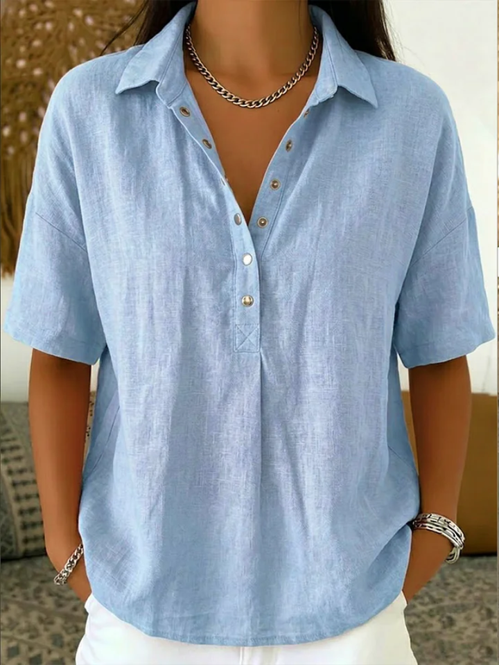 Casual yet chic women's short sleeve top featuring a turn-down collar, V-neck design, & button front.