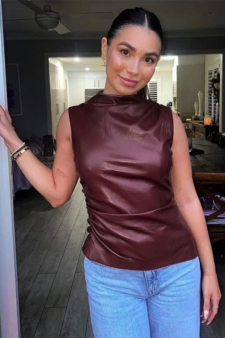 Modern women's sleeveless high neck summer top. Chic, elegant, and versatile black top for sophisticated fashion.